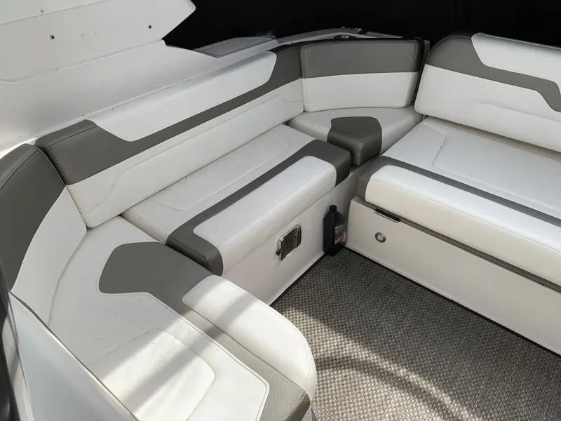 Slide: The Image of 2014 Monterey 320 Sport Yacht interior seating with white and gray upholstery. - 22