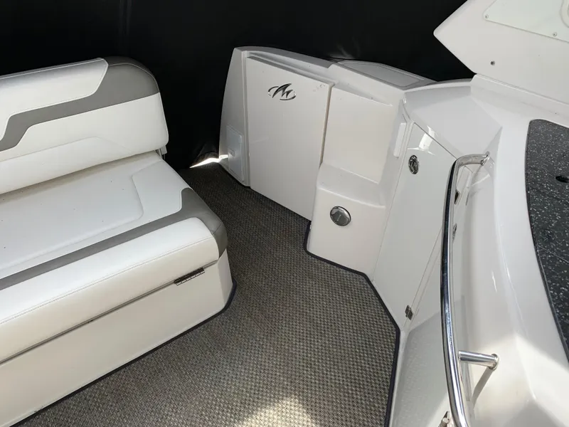 Slide: The Image of 2014 Monterey 320 Sport Yacht interior with white seating and carpeted flooring. - 23