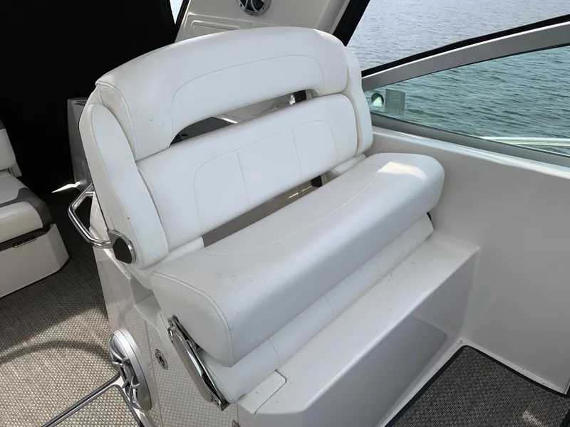 Slide: The Image of White leather seating on 2014 Monterey 320 Sport Yacht, overlooking water. - 24