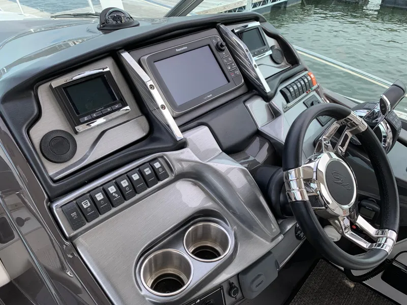 Slide: The Image of Dashboard of a 2014 Monterey 320 Sport Yacht with modern controls and steering wheel. - 27