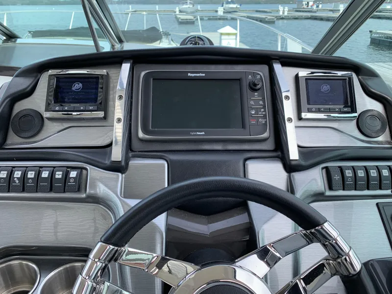 Slide: The Image of Dashboard of a 2014 Monterey 320 Sport Yacht with navigation controls and steering wheel. - 28