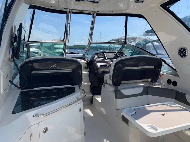 Slide: The Image of Interior of a 2014 Monterey 320 Sport Yacht, featuring helm and seating area. - 3