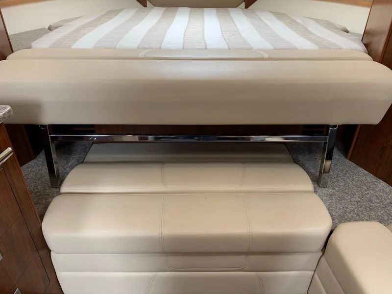 Slide: The Image of Interior of 2014 Monterey 320 Sport Yacht with beige leather seating and bed. - 34