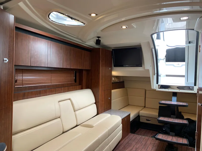 Slide: The Image of Interior of 2014 Monterey 320 Sport Yacht with beige seating and wood accents. - 38