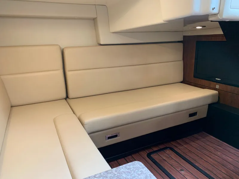 Slide: The Image of Interior of 2014 Monterey 320 Sport Yacht with beige seating and wood flooring. - 39