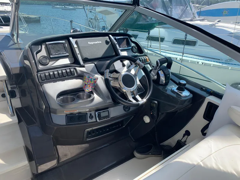 Slide: The Image of Cockpit of 2014 Monterey 320 Sport Yacht with steering wheel and navigation controls. - 4