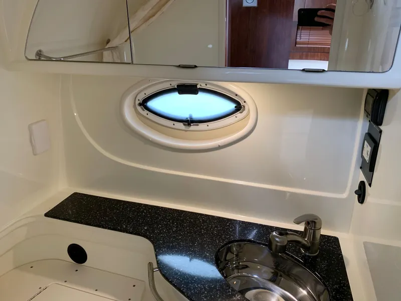 Slide: The Image of 2014 Monterey 320 Sport Yacht bathroom with sink, countertop, and oval window. - 42