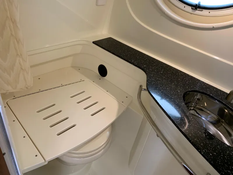 Slide: The Image of 2014 Monterey 320 Sport Yacht bathroom with sleek countertop and compact design. - 43