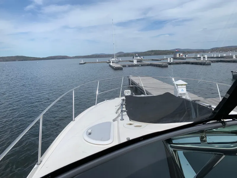 Slide: The Image of 2014 Monterey 320 Sport Yacht docked at a serene marina with calm waters. - 45