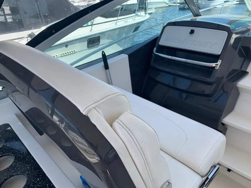 Slide: The Image of 2014 Monterey 320 Sport Yacht interior with white seating and sleek design. - 5