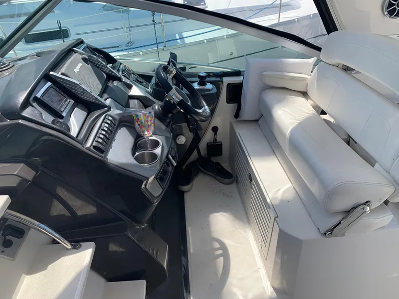 Slide: The Image of Cockpit of 2014 Monterey 320 Sport Yacht with white seating and modern controls. - 7