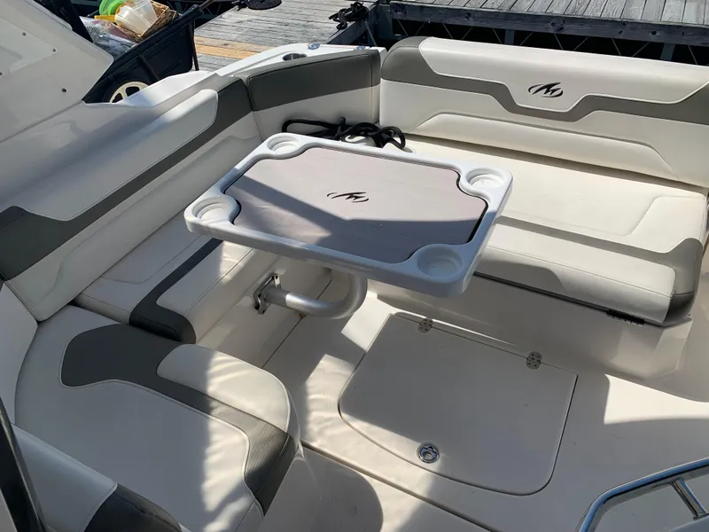 Slide: The Image of 2014 Monterey 320 Sport Yacht interior with seating and table on deck. - 8