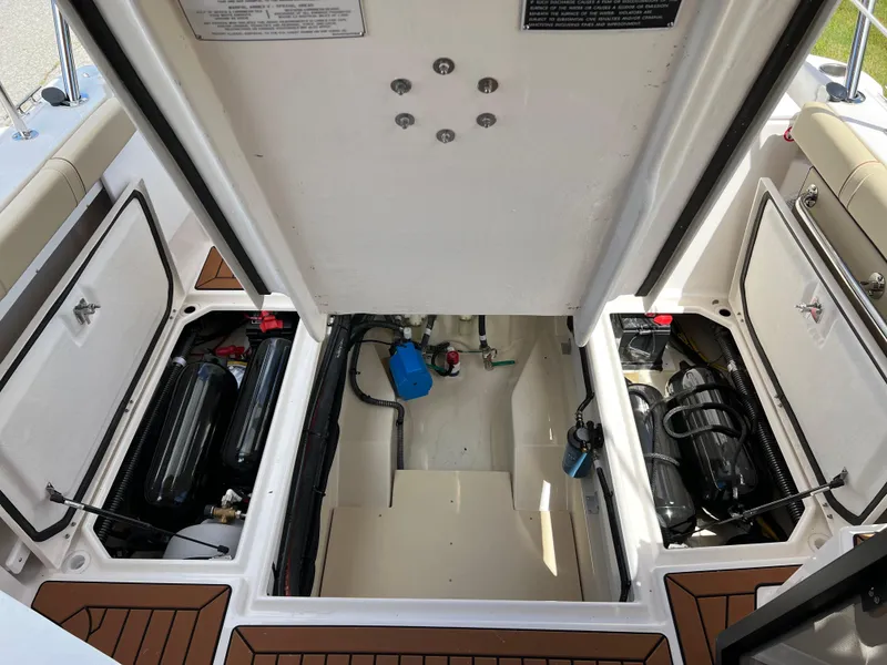 Slide: The Image of 2024 Ranger Tugs R-27 engine compartment, showcasing organized wiring and components. - 10