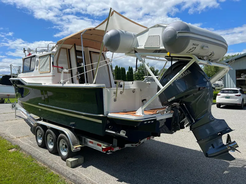 Slide: The Image of 2024 Ranger Tugs R-27 boat on trailer with Yamaha outboard motor. - 3