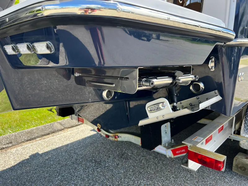 Slide: The Image of 2024 Ranger Tugs R-27 boat on trailer, rear view showing trim tabs and hull design. - 4