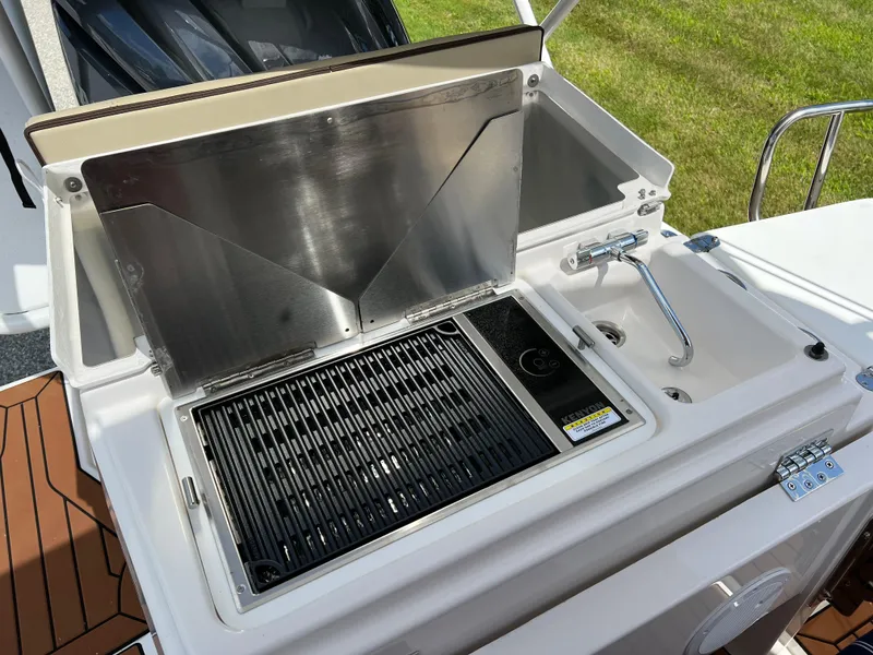 Slide: The Image of Outdoor kitchen on 2024 Ranger Tugs R-27 boat with grill and sink. - 8
