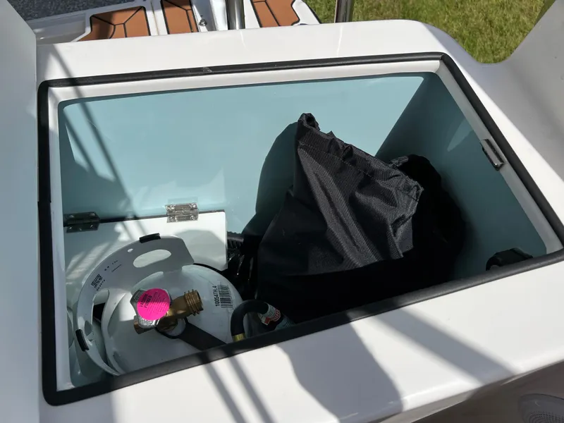 Slide: The Image of Storage compartment on 2024 Ranger Tugs R-27 boat with propane tank and bag. - 9