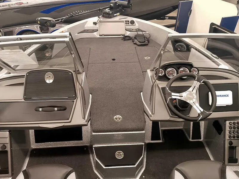 Slide: The Image of 2025 Ranger 1880MS Angler boat interior with dual consoles and steering wheel. - 11
