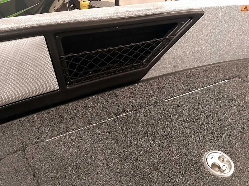 Slide: The Image of 2025 Ranger 1880MS Angler boat interior with storage net and carpeted surface. - 19