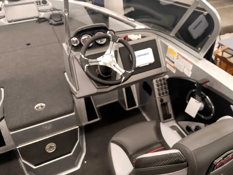 Slide: The Image of 2025 Ranger 1880MS Angler boat interior with steering wheel and dashboard controls. - 26