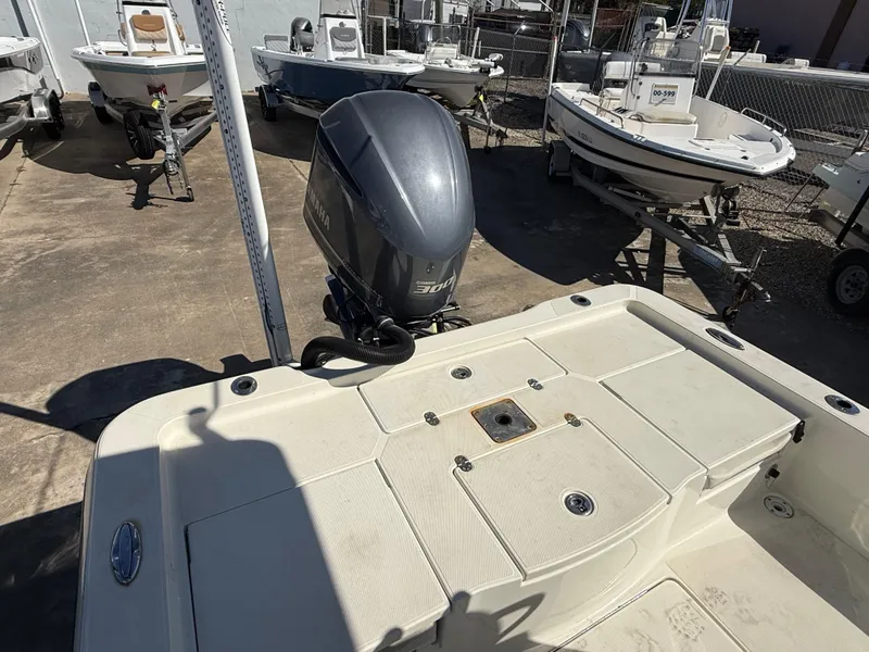 Slide: The Image of 2014 Ranger 2310 Bay boat with outboard motor in a marina setting. - 11