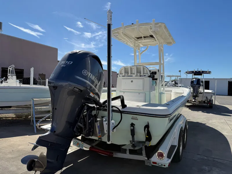 Slide: The Image of 2014 Ranger 2310 Bay boat with Yamaha engine on trailer, parked outdoors. - 13