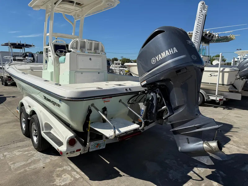 Slide: The Image of 2014 Ranger 2310 Bay boat with Yamaha outboard motor, parked on a trailer. - 14