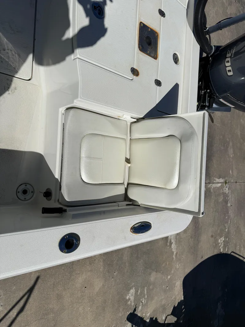 Slide: The Image of 2014 Ranger 2310 Bay boat with open storage compartment and cushioned seat. - 15