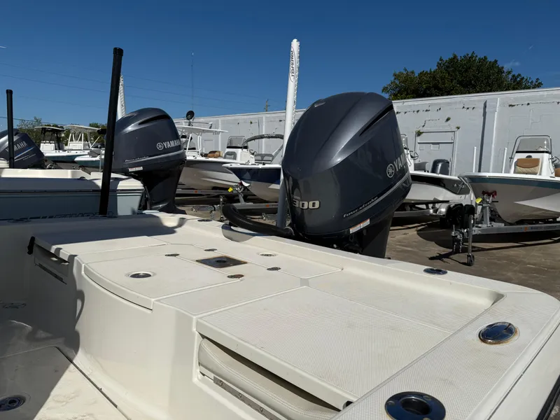Slide: The Image of 2014 Ranger 2310 Bay boat with Yamaha outboard engines in a marina setting. - 6