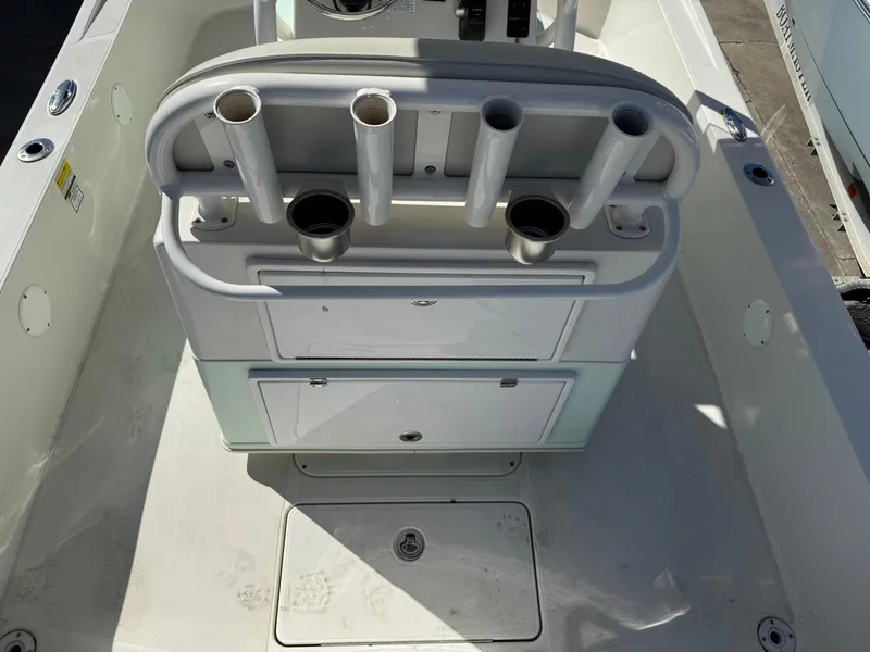 Slide: The Image of 2014 Ranger 2310 Bay boat interior with rod holders and storage compartments. - 8