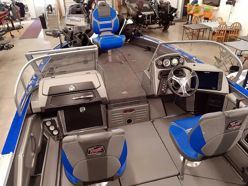 Slide: The Image of 2025 Ranger 620FS Fisherman boat interior with blue and gray seating, modern dashboard, and spacious layout. - 11