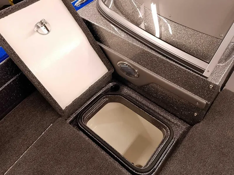 Slide: The Image of 2025 Ranger 620FS Fisherman boat storage compartment with open lid, showcasing interior details. - 13