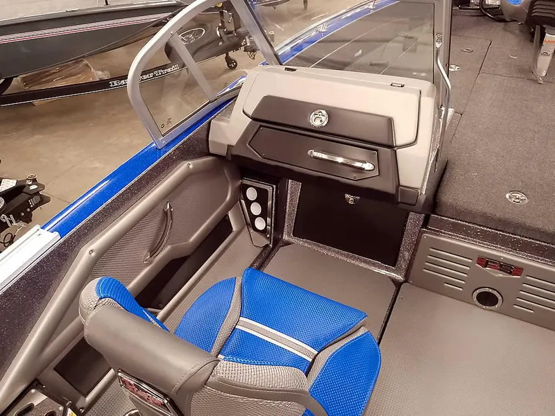 Slide: The Image of 2025 Ranger 620FS Fisherman boat interior with blue seating and modern dashboard design. - 18