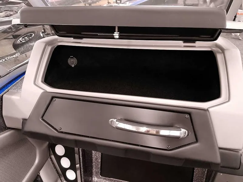 Slide: The Image of 2025 Ranger 620FS Fisherman boat dashboard with open storage compartment. - 20