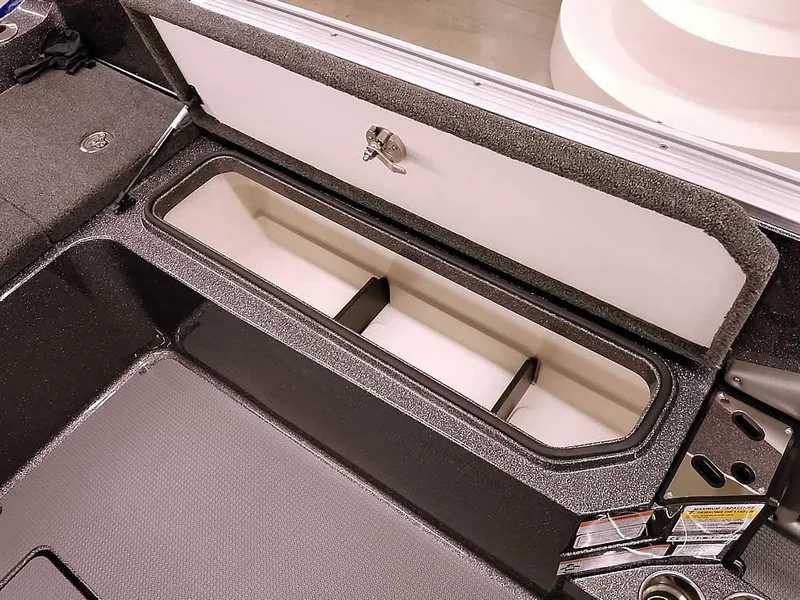 Slide: The Image of 2025 Ranger 620FS Fisherman boat storage compartment, open lid, interior view. - 28