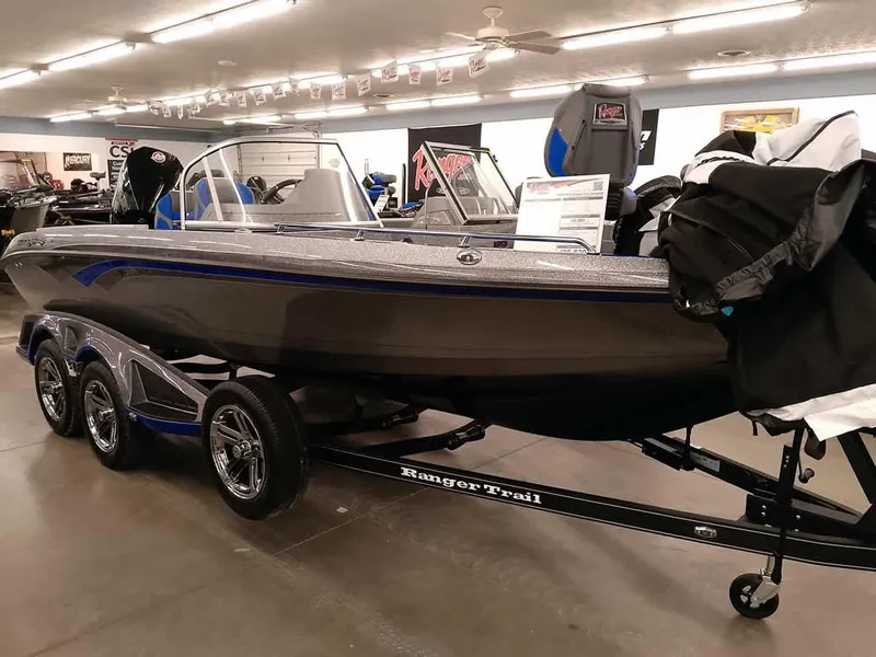 Slide: The Image of 2025 Ranger 620FS Fisherman boat displayed indoors on a trailer. - 35