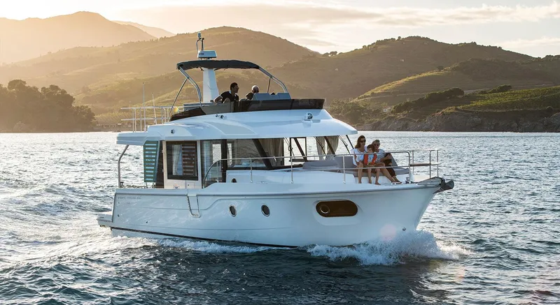 Slide: The Image of 2026 Beneteau Swift Trawler 41 Fly cruising on scenic waters at sunset. - 0