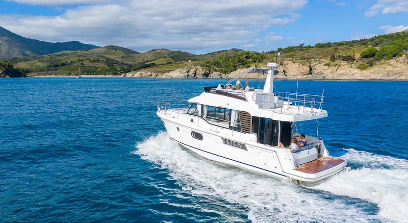 Slide: The Image of 2026 Beneteau Swift Trawler 41 Fly cruising on scenic blue waters. - 1