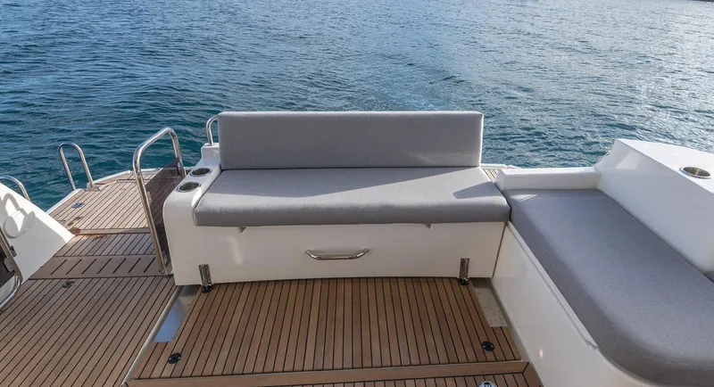 Slide: The Image of Beneteau Swift Trawler 41 Fly 2026, featuring elegant deck seating by the water. - 2