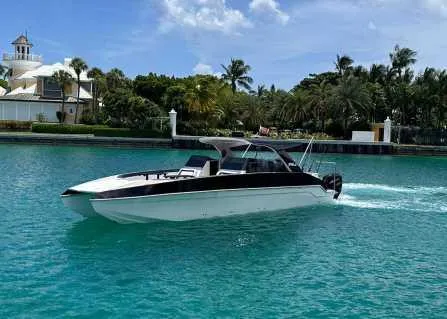 The Image of 2022 Catamaran PRJ Cat40 cruising on turquoise water under a clear blue sky. - 0