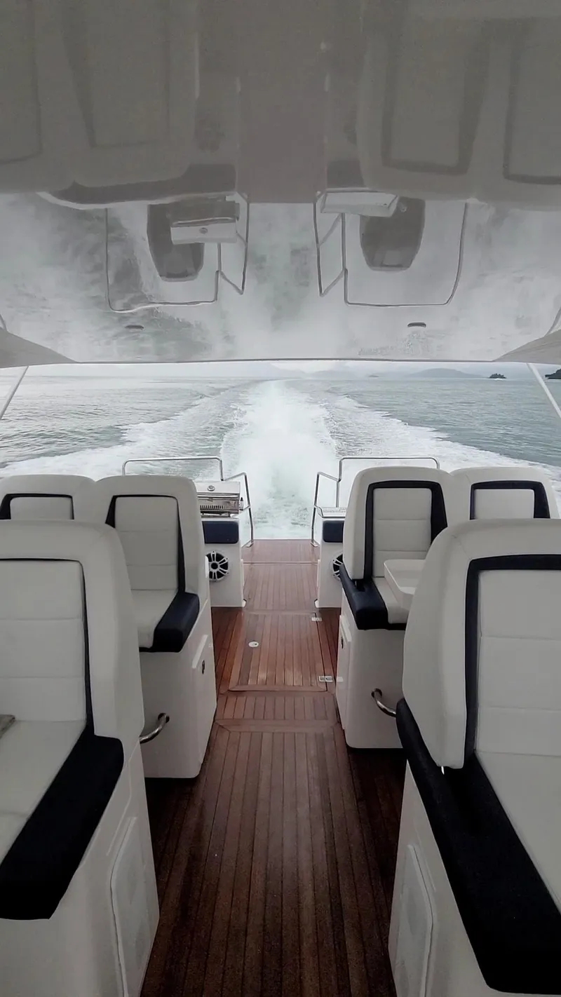 Slide: The Image of 2022 Catamaran PRJ Cat40 interior with white seating and wooden flooring on open water. - 12