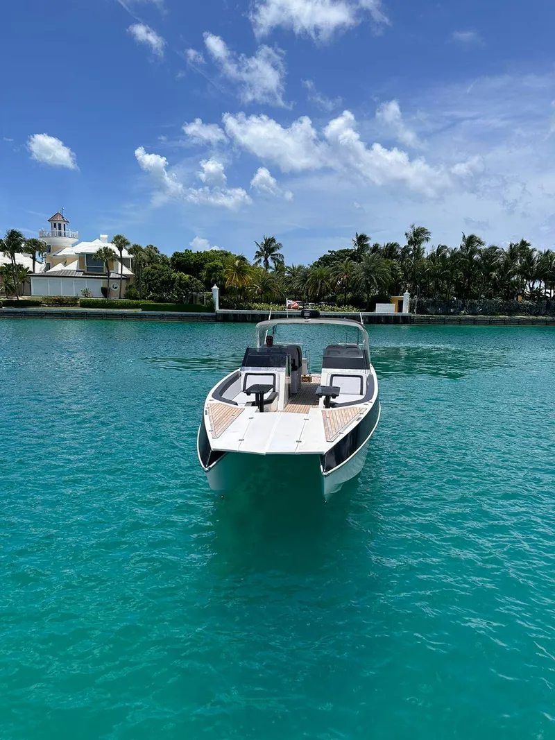 Slide: The Image of 2022 Catamaran PRJ Cat40 on turquoise water, clear sky, lush background. - 16
