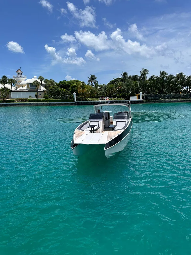 Slide: The Image of 2022 Catamaran PRJ Cat40 on turquoise water near lush shoreline. - 20