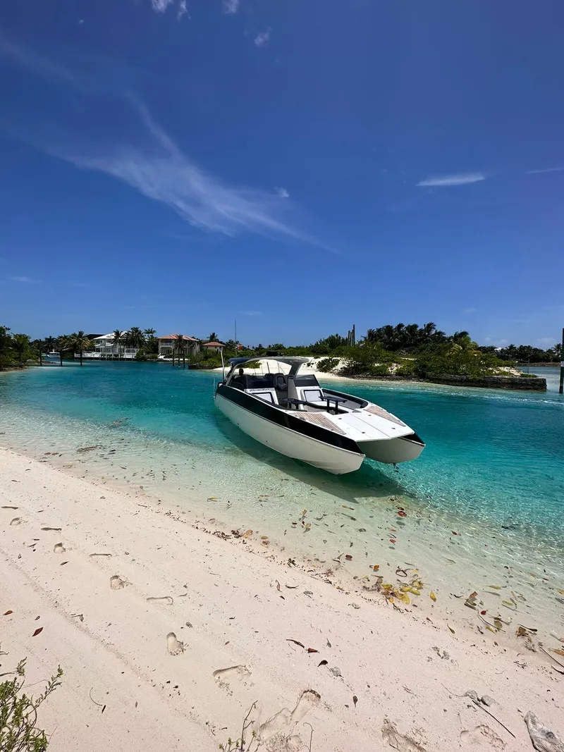 Slide: The Image of 2022 Catamaran PRJ Cat40 anchored on a pristine beach with turquoise waters and clear skies. - 3