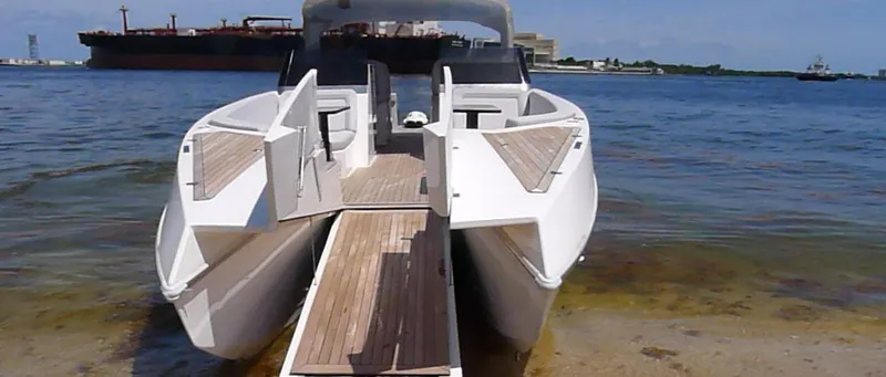 Slide: The Image of 2022 Catamaran PRJ Cat40 docked on a sunny shoreline with wooden deck. - 6