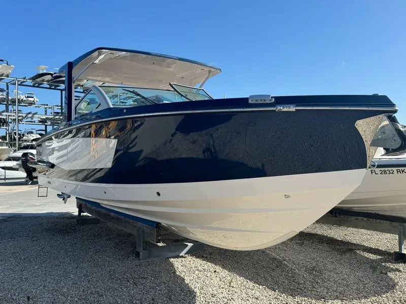 Slide: The Image of 2023 Aviara AV32 OB boat with sleek design, displayed outdoors on a sunny day. - 0