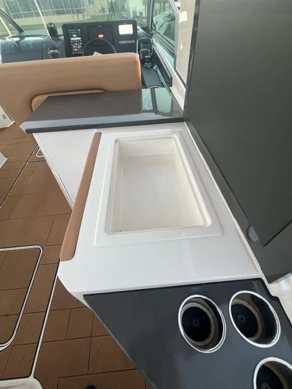 Slide: The Image of 2023 Aviara AV32 OB boat interior with sleek countertop and built-in cup holders. - 12