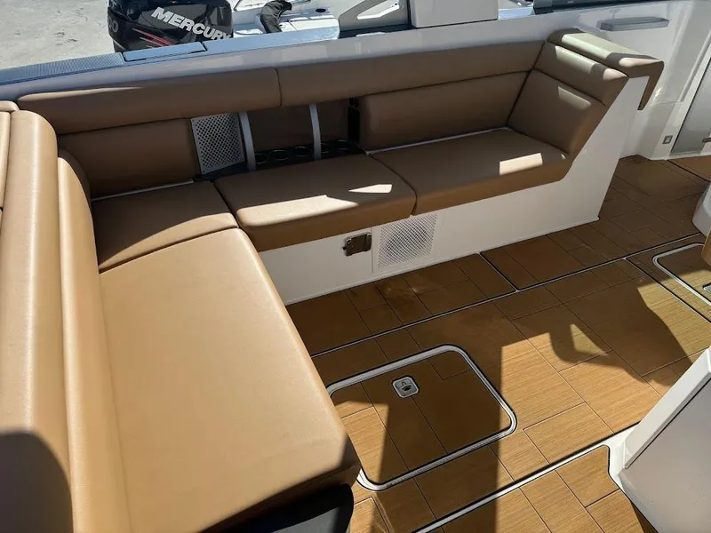Slide: The Image of 2023 Aviara AV32 OB boat interior with tan seating and wood flooring. - 13