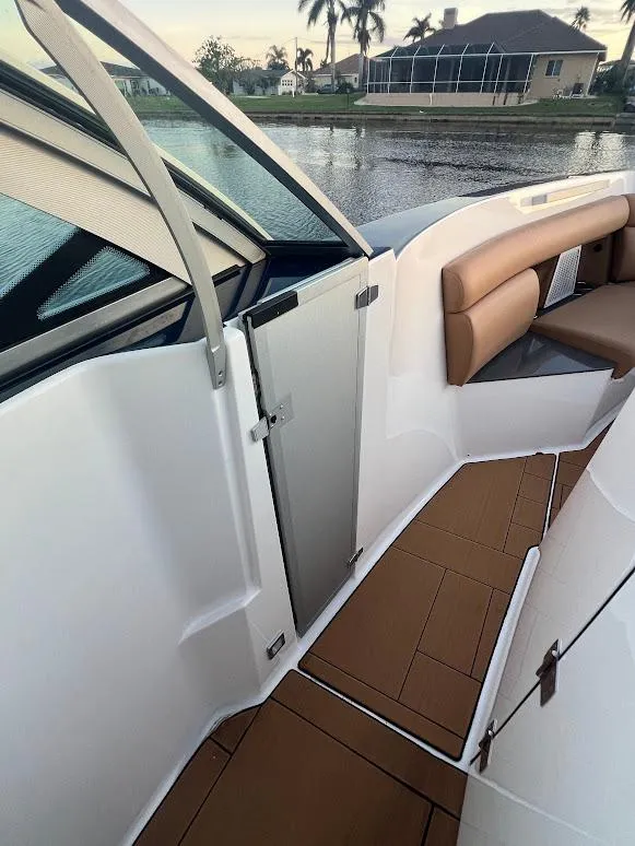 Slide: The Image of 2023 Aviara AV32 OB boat interior with brown seating and sleek design. - 15