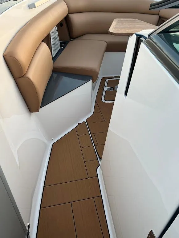 Slide: The Image of 2023 Aviara AV32 OB interior with tan seating and wood-style flooring. - 16